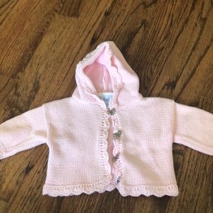 Pink cardigan with bow details at buttons
